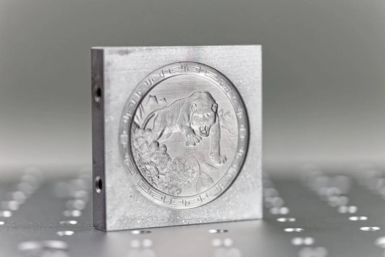 Tiefengravur mit Relief in Metall
